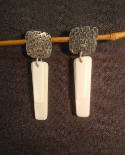 Striking textured Earrings with bone drops in silver color